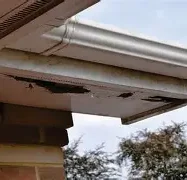 rotted fascia and soffit orpington Damaged roof edge showing wear and missing sections.